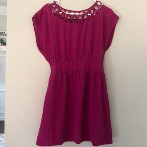 Pink dress with cutout neck design.